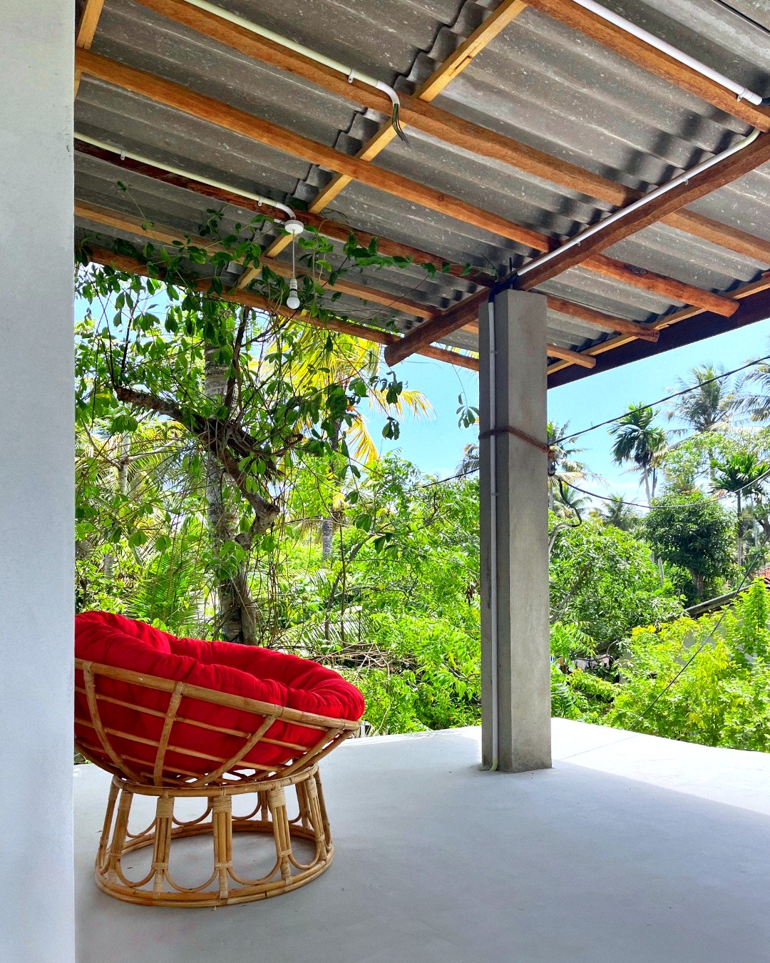 Domi Casa, rooftop terrace with red papasan chair