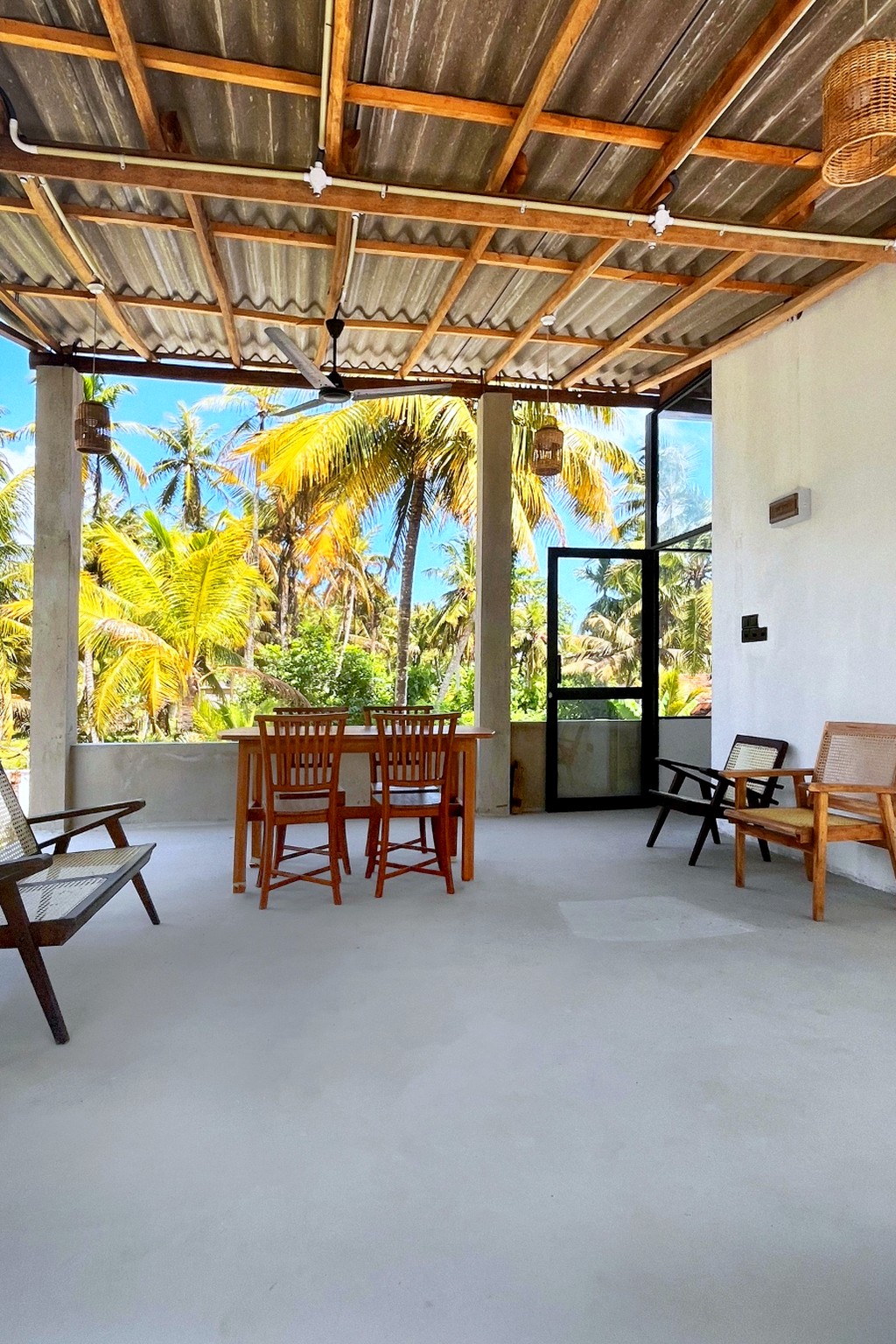 Casa rooftop deck with teak dining set and lounge chairs