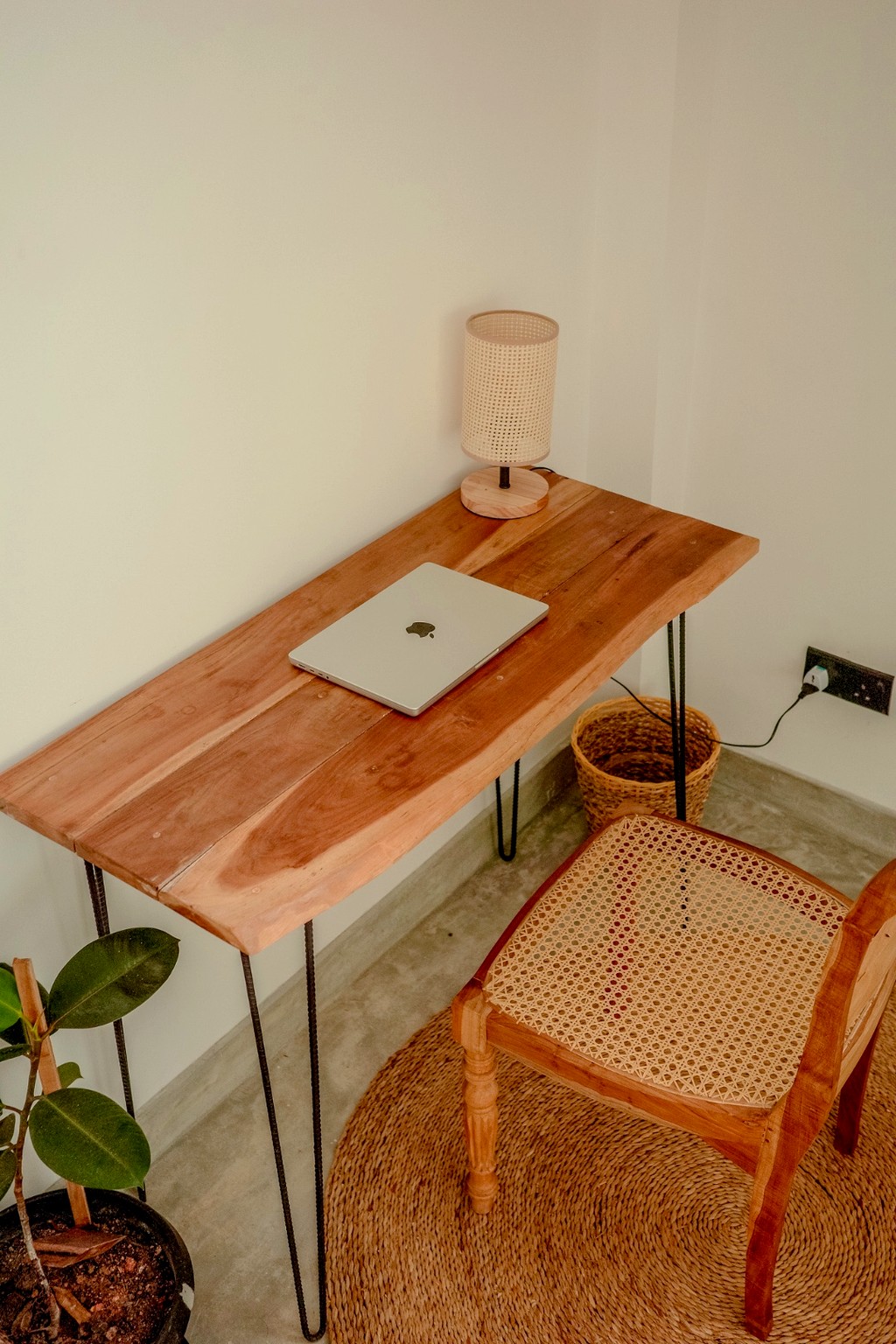 Casa workspace · live-edge desk, lamp and wicker chair