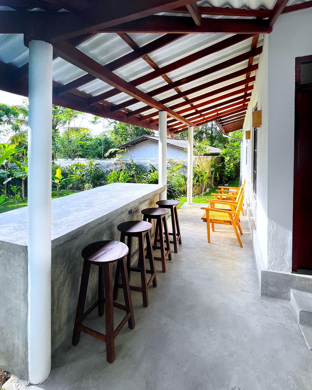 Safiya · outdoor bar with stools under the veranda