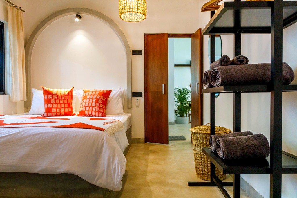 Safiya bedroom one · alcove bed, woven pendant, open shelving