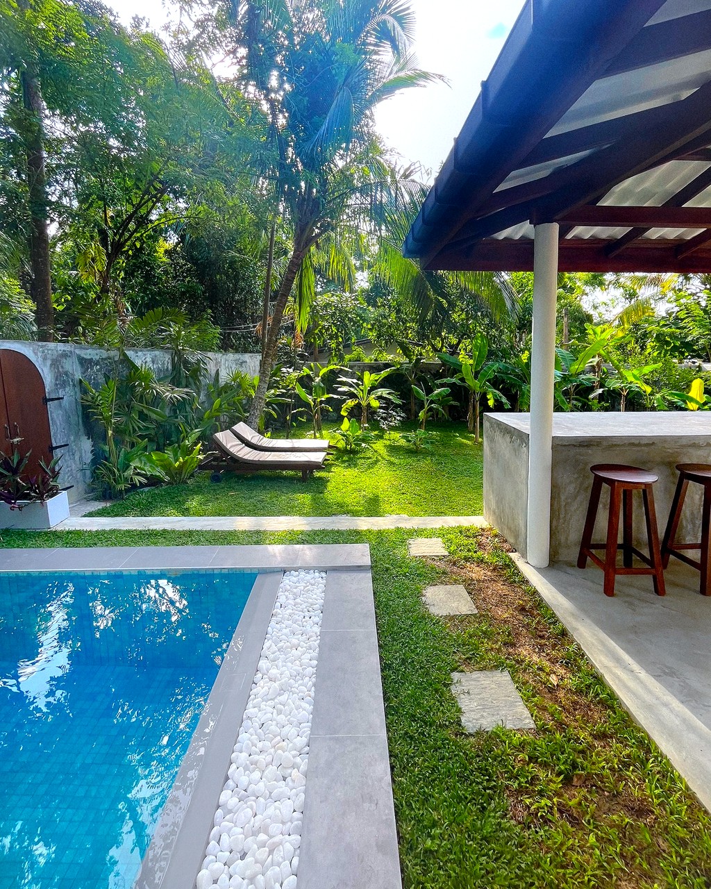Safiya · pool, stepping stones and loungers, the bar beyond