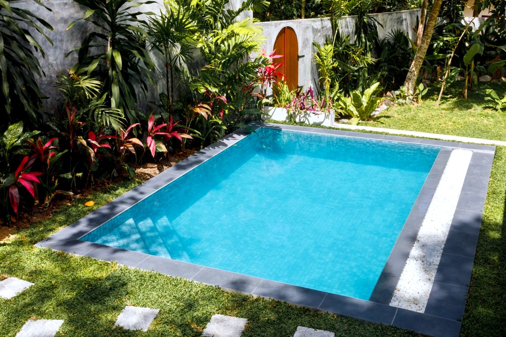 Safiya pool · wide view with the garden wall and arched door